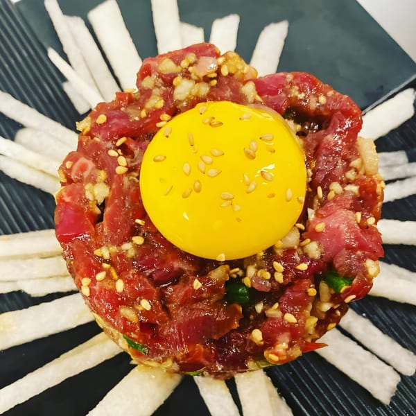 Gosu Korean BBQ's yukhoe, a Korean beef tartare dish with a raw egg yolk and sesame seeds.